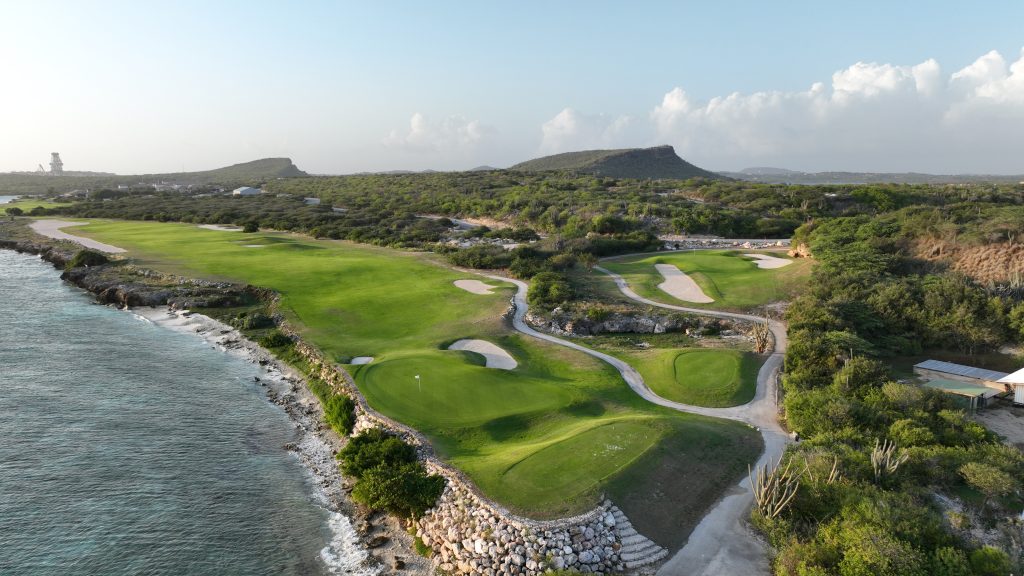 Signature aerial view of Hole 2 with Caribbean coastline and Hole 3 visible on the right at Old Quarry Golf Course Curaçao