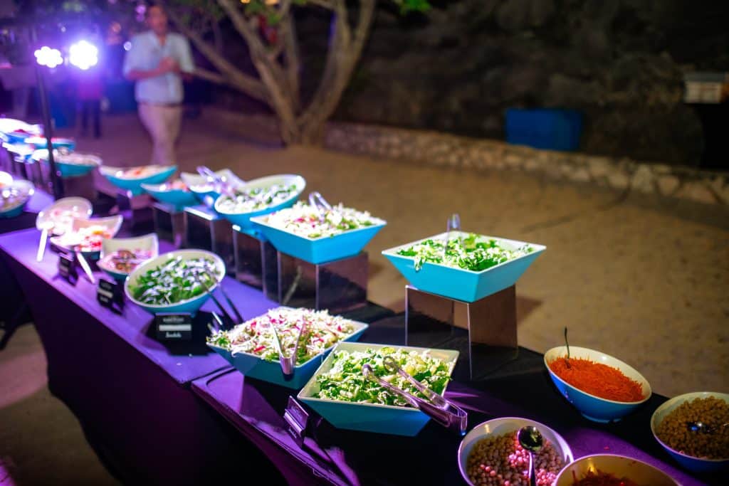 Colorful salad and appetizer buffet setup during night event at Old Quarry Golf Course Curaçao