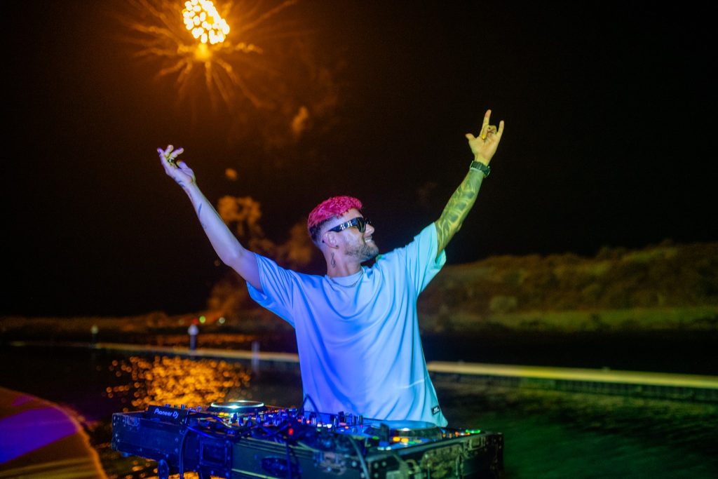 DJ with pink hair performing during night award ceremony with fireworks at Old Quarry Golf Course Curaçao