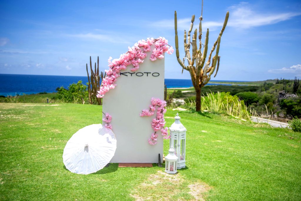 Kyoto sponsor sign with cherry blossoms at golf hole overlooking Caribbean Sea in Curaçao