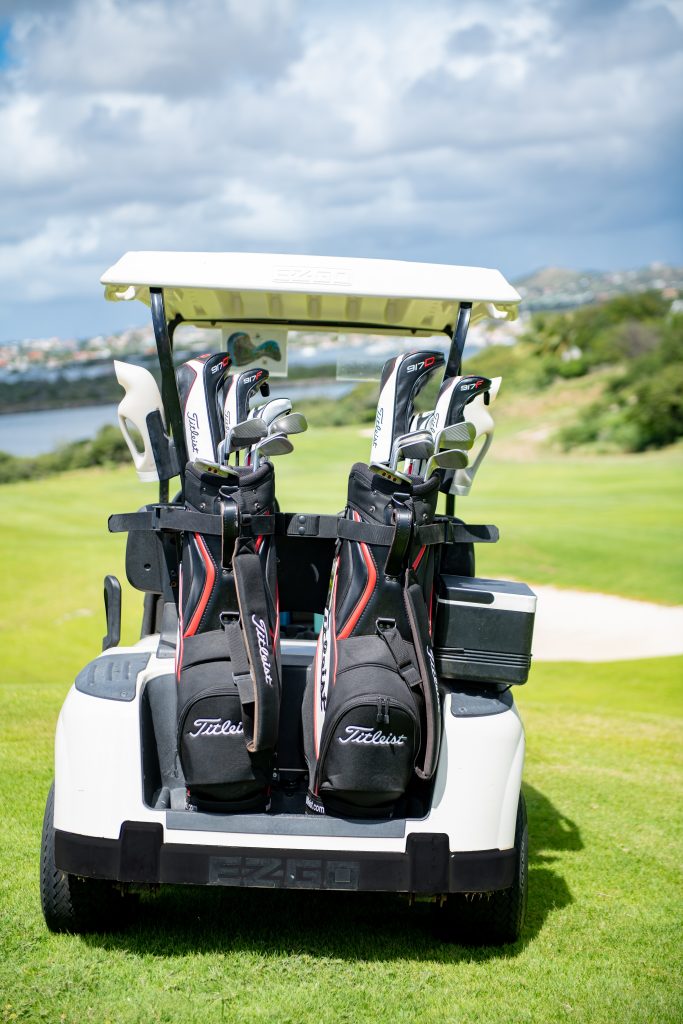 Close-up of a golf cart with two Titleist golf bags and clubs on the fairway at Old Quarry Golf Course